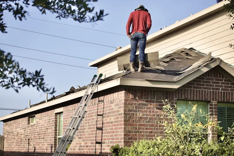 Professional roofer working on a residential roof in Summerland Hills